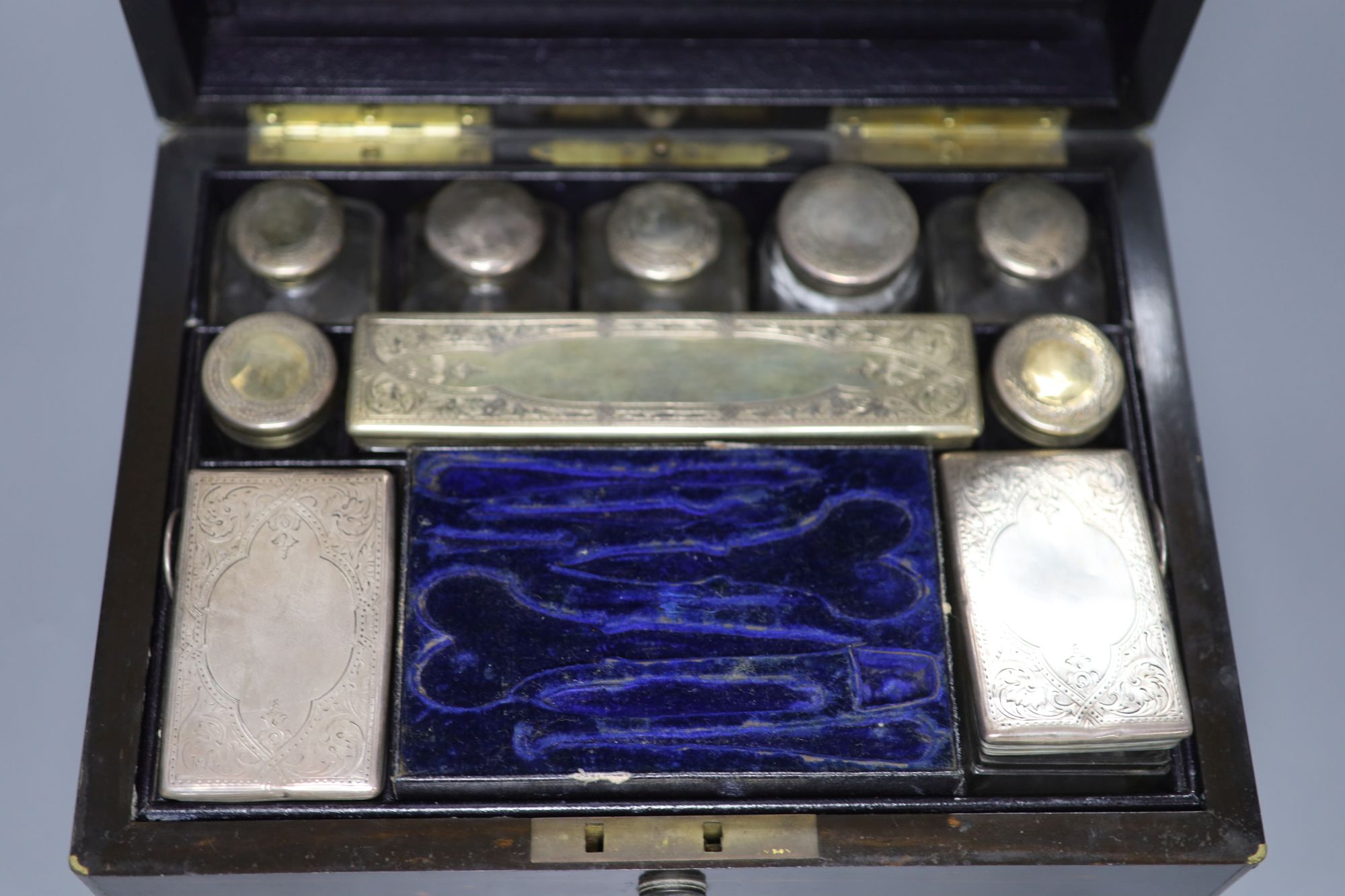 A Victorian coromandel toilet box with silver mounted toilet jars(four lids unmarked), retailed by Asprey & Co,